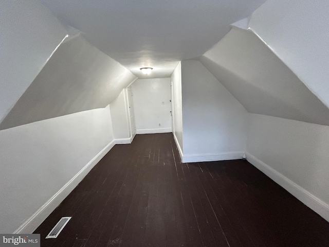 bonus room with dark hardwood / wood-style floors and lofted ceiling