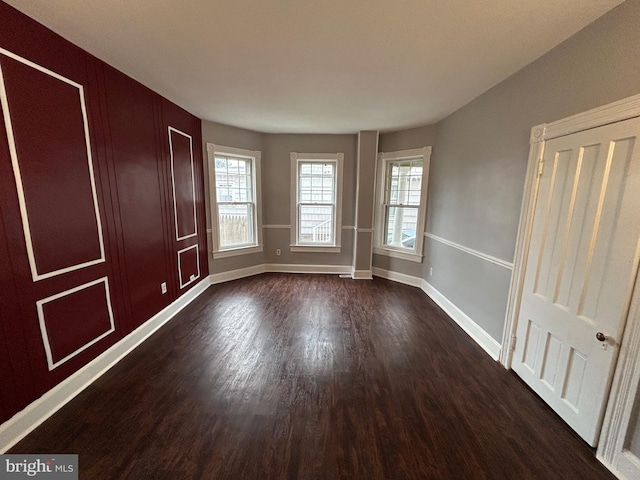 unfurnished room featuring dark hardwood / wood-style floors