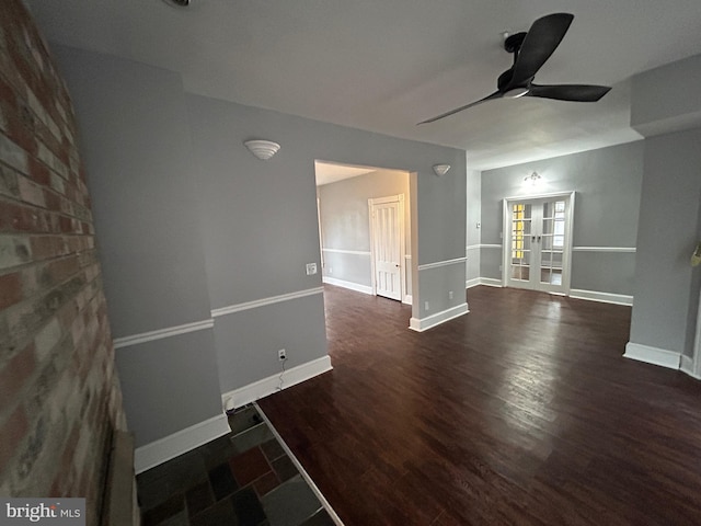 unfurnished room with ceiling fan and dark hardwood / wood-style flooring