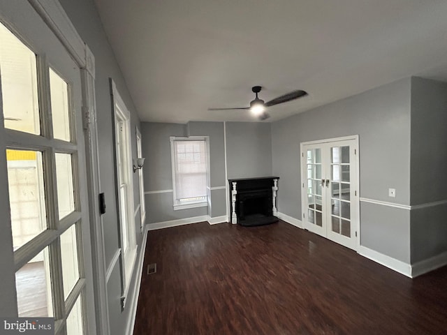 unfurnished living room featuring ceiling fan, dark wood-type flooring, and french doors