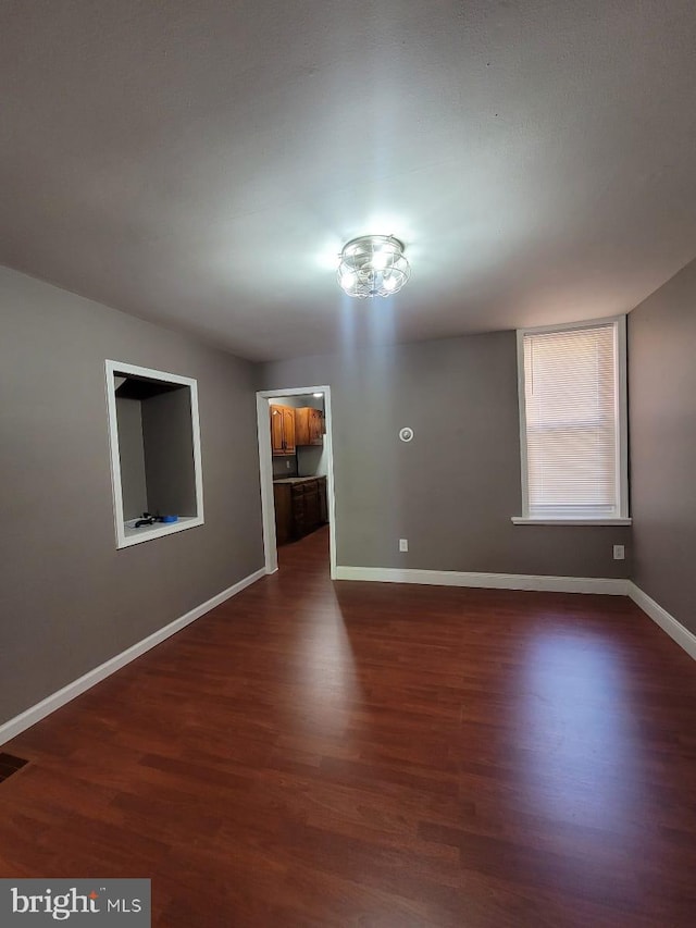 spare room with dark hardwood / wood-style floors