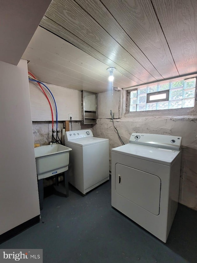 laundry area featuring washer and clothes dryer, wooden ceiling, and sink