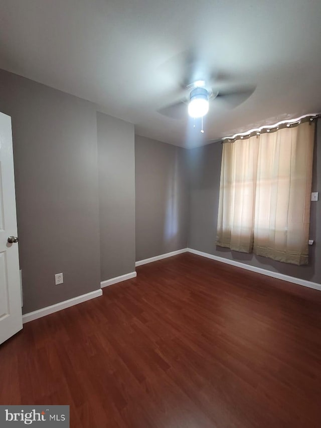 unfurnished room featuring ceiling fan and dark hardwood / wood-style flooring