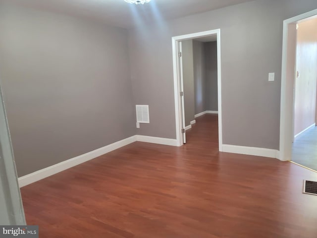 empty room with hardwood / wood-style flooring