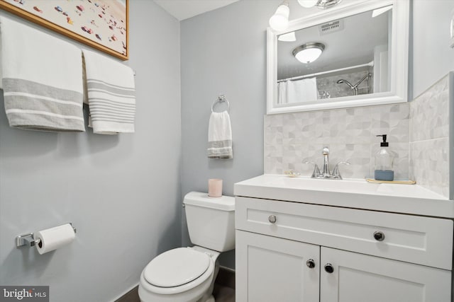 bathroom featuring vanity, backsplash, toilet, and a shower with shower curtain