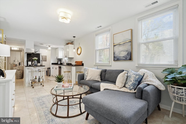 living room with a healthy amount of sunlight and light tile patterned flooring