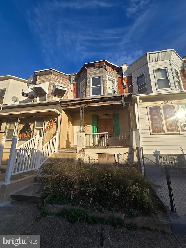 townhome / multi-family property with a porch