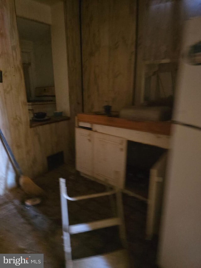 basement featuring wood walls