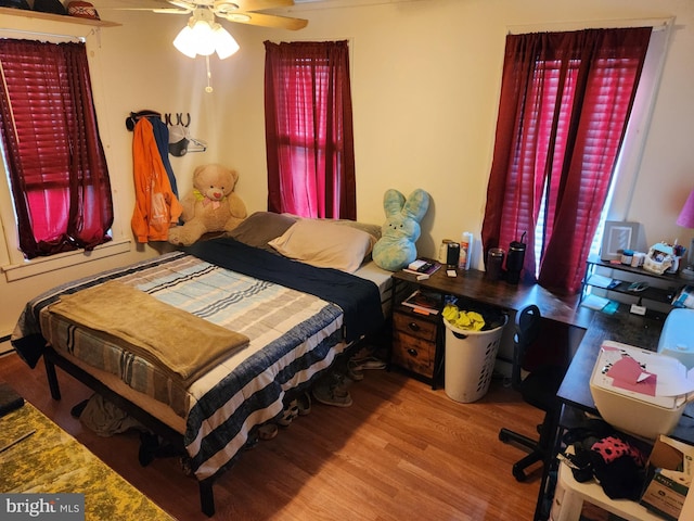 bedroom with hardwood / wood-style floors and ceiling fan