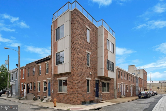 view of property featuring a residential view and entry steps