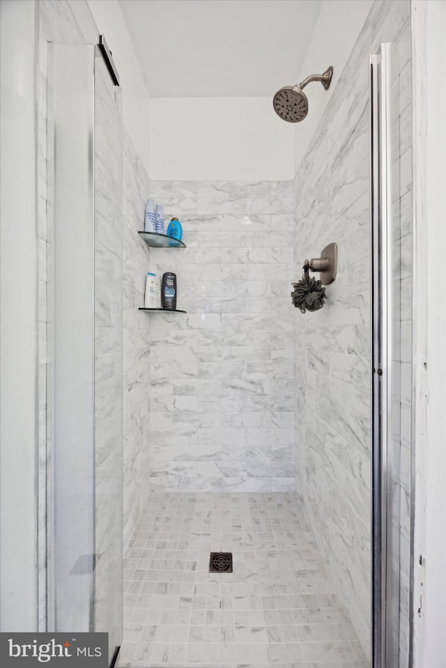 bathroom with tiled shower