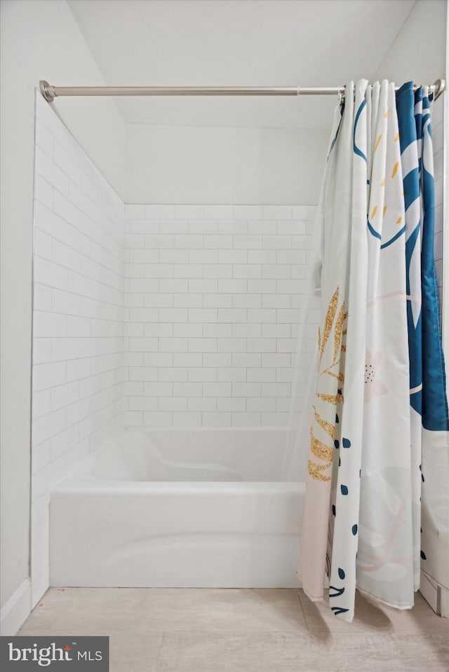 bathroom featuring shower / bath combo with shower curtain