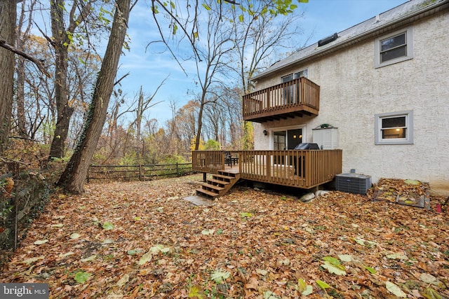 back of house featuring a balcony, a deck, and central AC unit