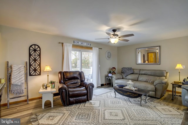 living room featuring hardwood / wood-style floors and ceiling fan