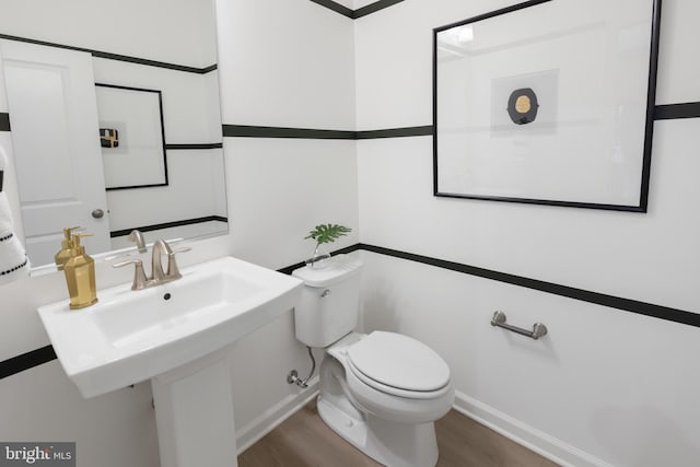 bathroom featuring hardwood / wood-style floors and toilet