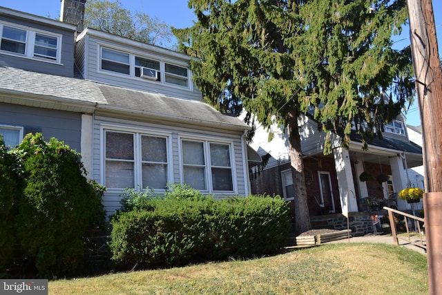 view of side of home with a lawn