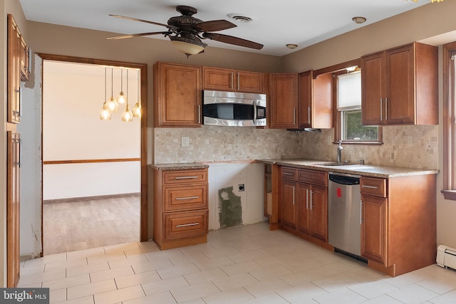 kitchen featuring sink, ceiling fan, decorative backsplash, light stone countertops, and appliances with stainless steel finishes