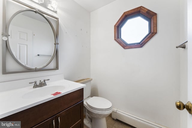 bathroom with tile patterned floors, vanity, toilet, and a baseboard radiator