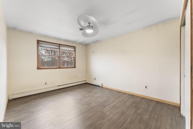 spare room featuring hardwood / wood-style flooring and baseboard heating