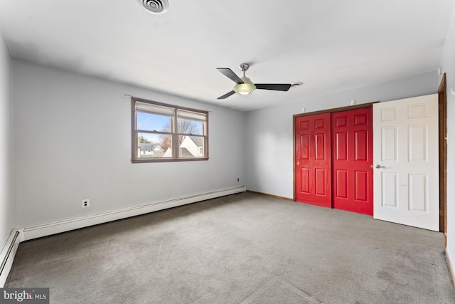 unfurnished bedroom with ceiling fan, carpet floors, baseboard heating, and a closet