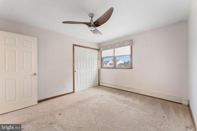 unfurnished bedroom featuring light colored carpet, ceiling fan, and a baseboard heating unit