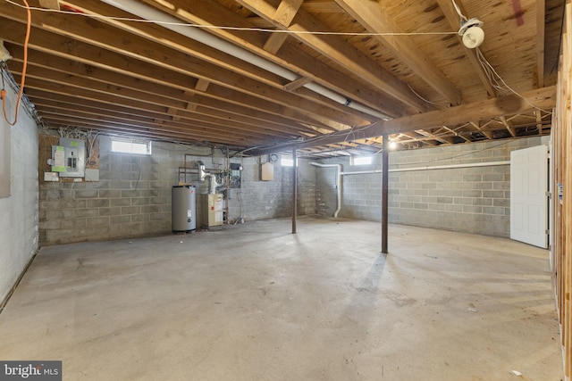 basement with electric panel and water heater