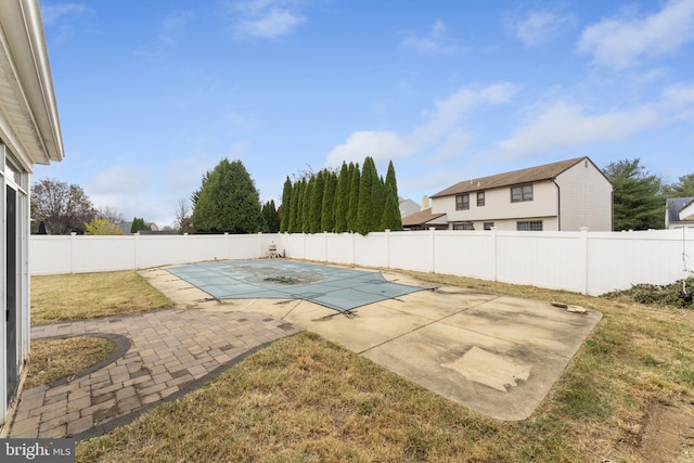 view of swimming pool with a lawn and a patio