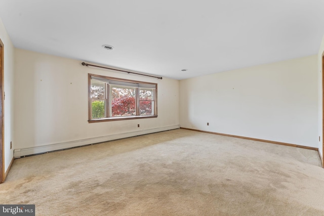 carpeted empty room featuring a baseboard heating unit