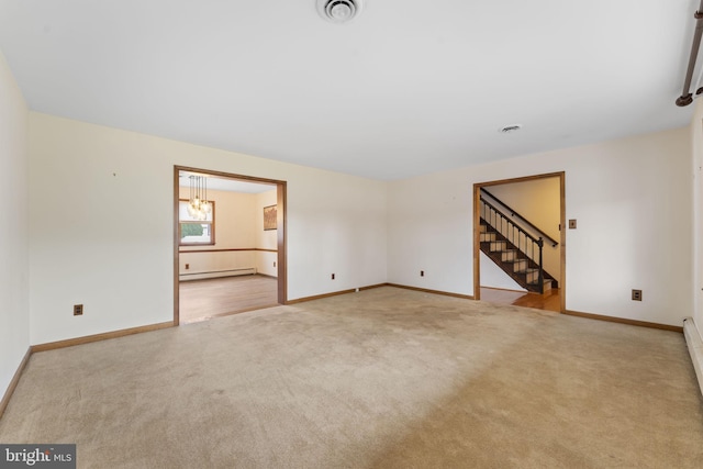 unfurnished room featuring a baseboard radiator and light colored carpet