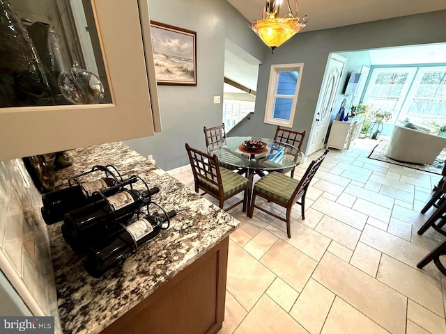 dining space featuring light tile patterned floors and baseboards