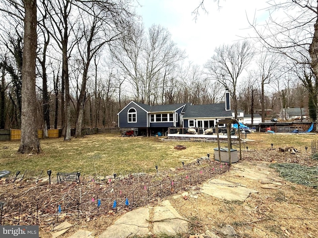 view of front of property with a chimney, fence, and a front yard