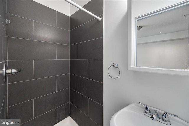 bathroom with a tile shower