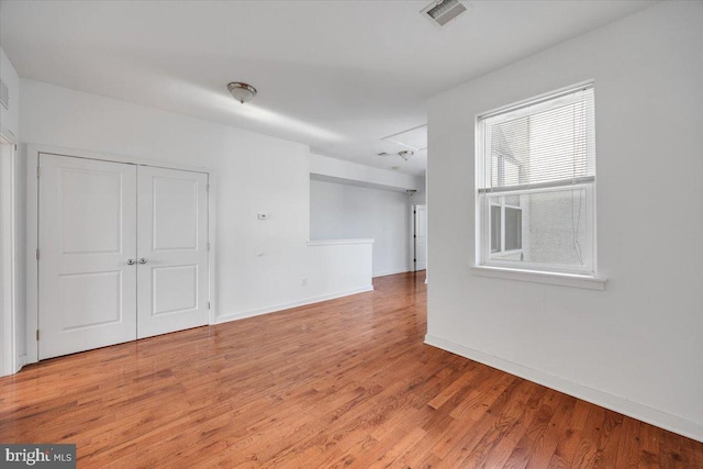 spare room with hardwood / wood-style flooring