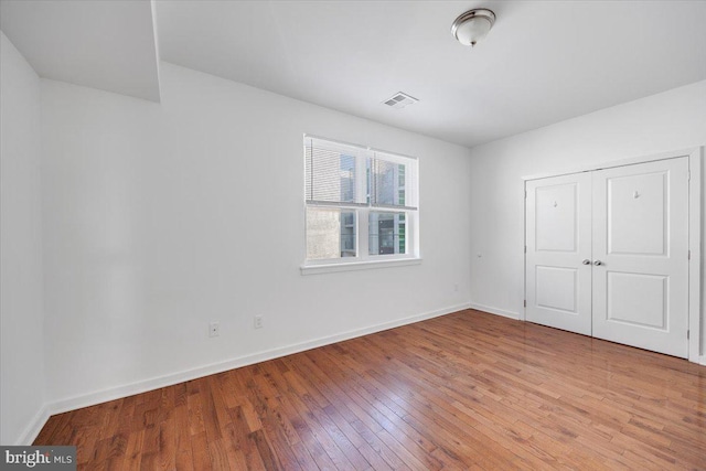 unfurnished bedroom featuring a closet and light hardwood / wood-style flooring