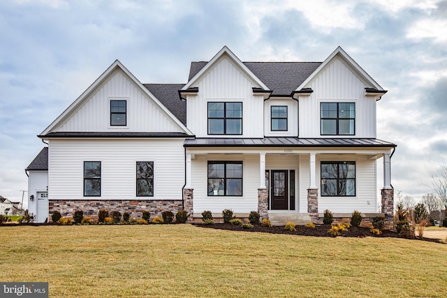 modern inspired farmhouse with a front yard and a porch