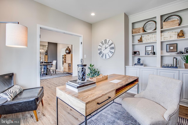 home office with light hardwood / wood-style flooring