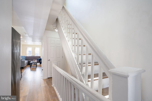 stairs with hardwood / wood-style flooring