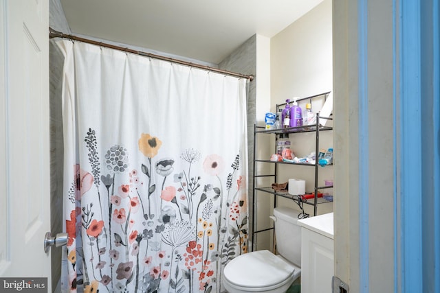 bathroom with vanity, toilet, and walk in shower