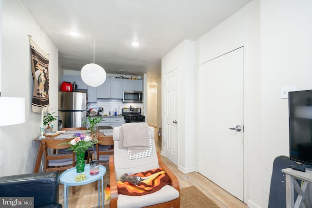 living room with light hardwood / wood-style flooring