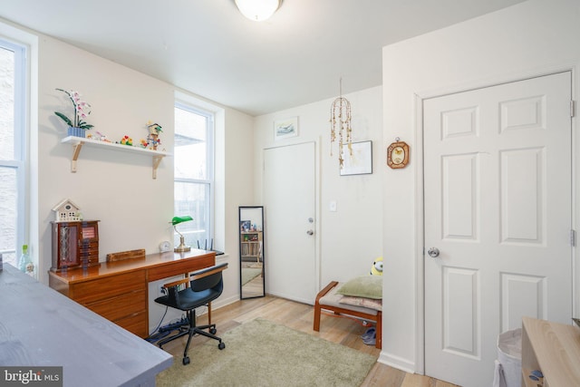 office featuring an inviting chandelier and light hardwood / wood-style flooring