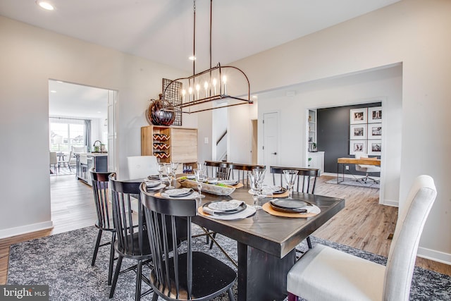 dining area featuring an inviting chandelier and light wood-type flooring