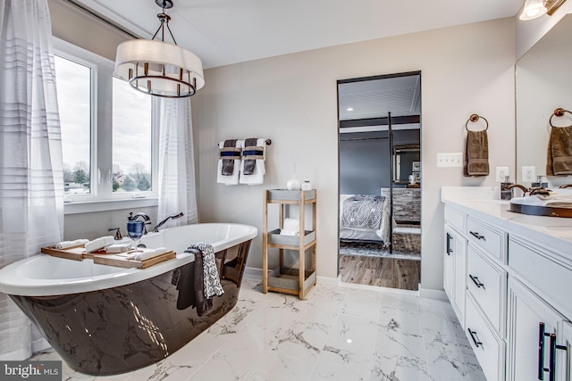 bathroom featuring wood-type flooring, vanity, and a tub