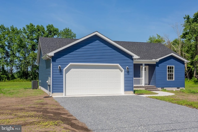 ranch-style home with central AC unit and a garage