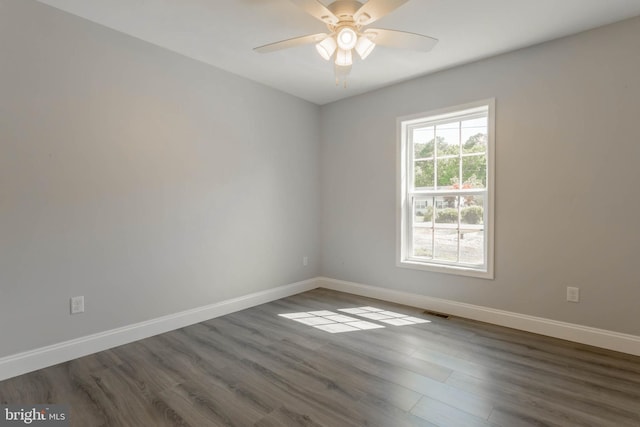 unfurnished room featuring ceiling fan and dark hardwood / wood-style flooring