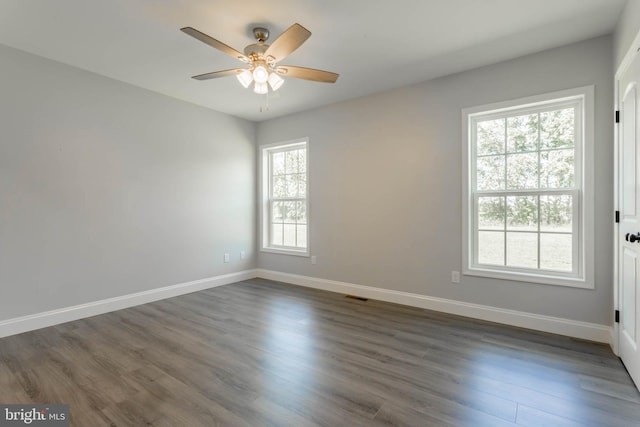 empty room featuring dark hardwood / wood-style floors and ceiling fan