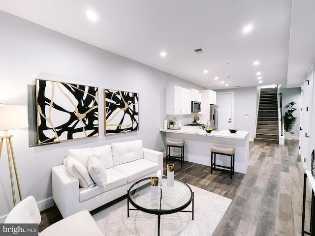1268 Holbrook Ter NE Unit 1, Washington, DC 20002 - living room with stairway, light wood finished floors, recessed lighting, and baseboards