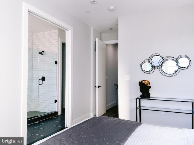 unfurnished bedroom featuring dark tile patterned flooring and connected bathroom