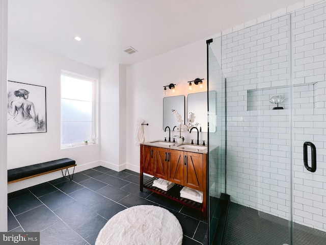 bathroom featuring tile patterned floors, vanity, and a shower with door