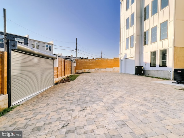 1268 Holbrook Ter NE Unit 1, Washington, DC 20002 - view of patio / terrace with central AC unit, decorative driveway, and an attached garage