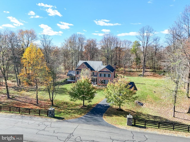 view of property's community featuring a lawn and a rural view